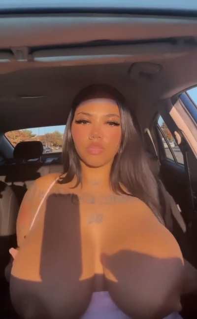 Popping those fat titties out in the car