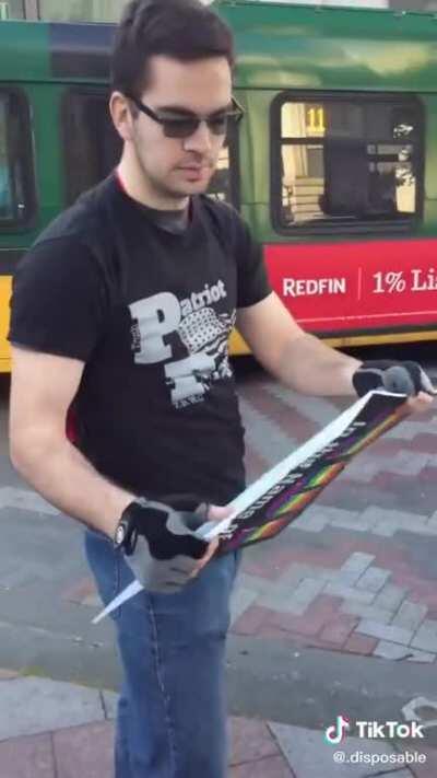 Far right activist tries to rip up pride sign.