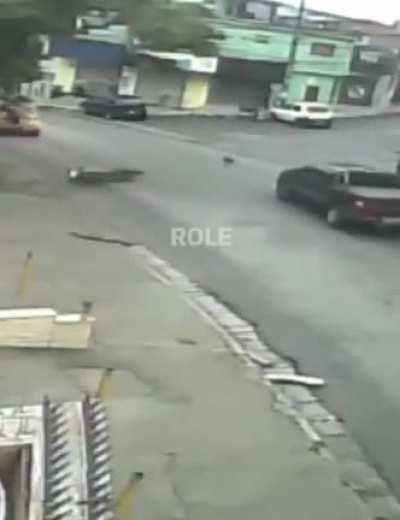 Driver who ran over biker is arrested after victim calls police from the roof of the truck