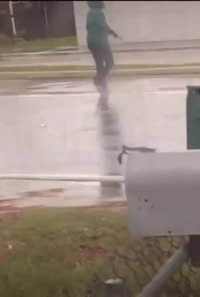 Woman pointing gun at random cars on the road
