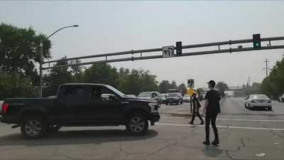 Protester gets sent flying after jumping on highway patrol vehicle - Sacramento, CA 14th September