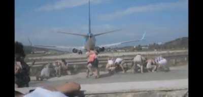 DBS standing behind an airplane that is taking off!