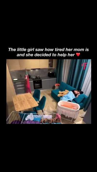 The little girl helping her tired mom