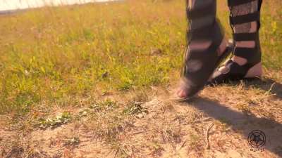 Helga Li strikes again—this time in gladiator sandals. Relaxed and confident, she crushes hard snail shells with her delicate feet as if they were mere scum.