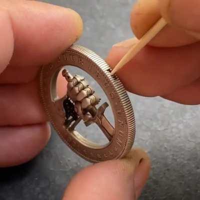 A modified US 1 Dollar Coin with a Hidden Button for Clasping and Unclasping a Sword