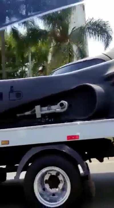 Batmobile being towed by the Joker