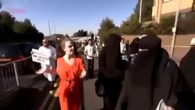 Protestor tries to shame reporter for not dressing like her