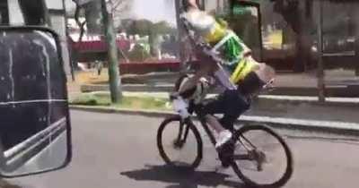 Riding a bike with a big Jesus statue on your back and not looking where you're going