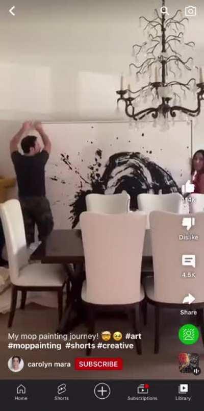 Lady uses a mop to make “Abstract Art”