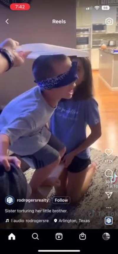 Sisters lift their brother to the “ceiling”.