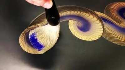 Keisuke Teshima painting the body of a dragon in a single stroke