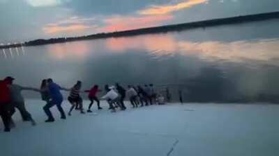 People in Perm, Russia, made a chain out of 30 people to rescue a drowning woman from the lake