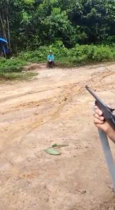Shooting can of beer on the head of a drunk guy