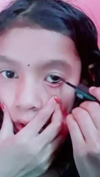 Applying eyeliner