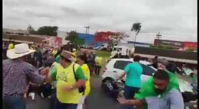 Protesters in Brazil, against the results of the elections, are blocking the roads around the country. Driver runs over some of them, including kids.
