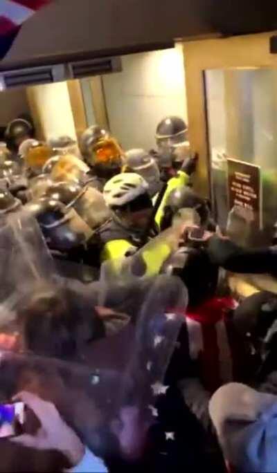 MAGA protestors spraying pepper spray at the police officers, in the Capitol Building