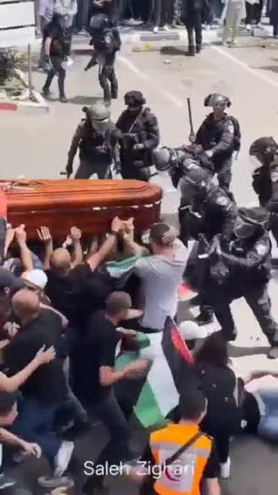 Israel forces assaulting mourners during the funeral of Aljazeera journalist Sherin Abu Aqla