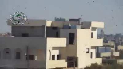 Opposition cameraman catches the moment an SAA delayed fuse artillery round impacts and detonates - Daraa - 12/16/2013