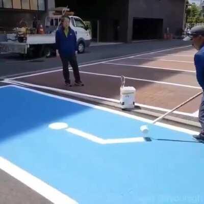 I had no idea these were done freehand, painting a disabled parking sign that is. Steady now.