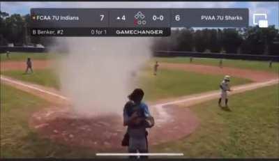 Umpire Pulls Kid Out of Dust Devil