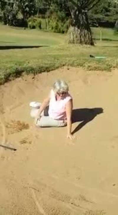 Hitting out of a sand trap.