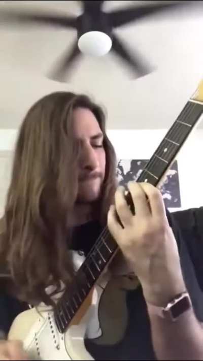 Why is bro looking at his guitar like that