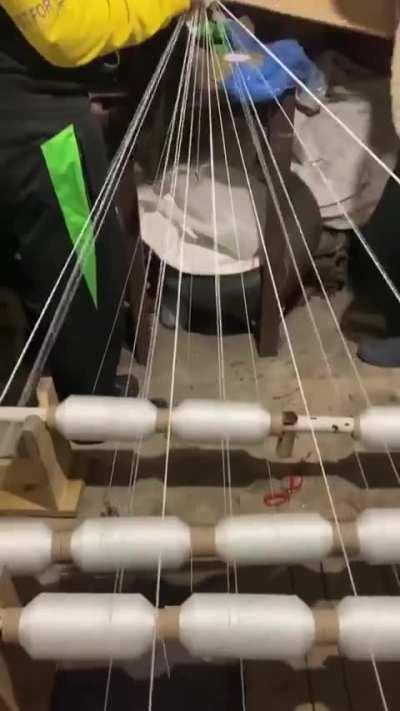 School kids in Chernihiv weave white snow camo nets in their spare time.