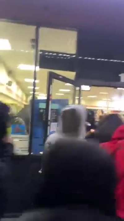 People looting a 7-Eleven store at a street takeover in LA