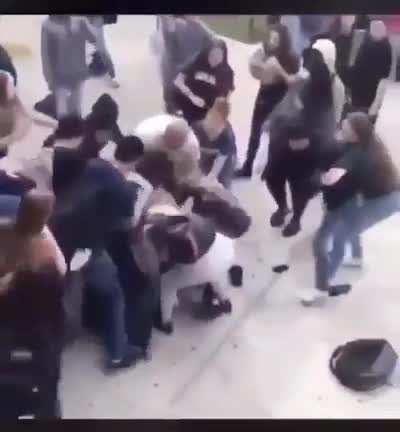 Huge fight breaks out when a girl pulls and hits the boy on head.