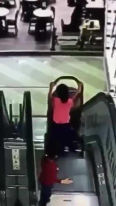 WCGW Pushing a stroller down a escalator