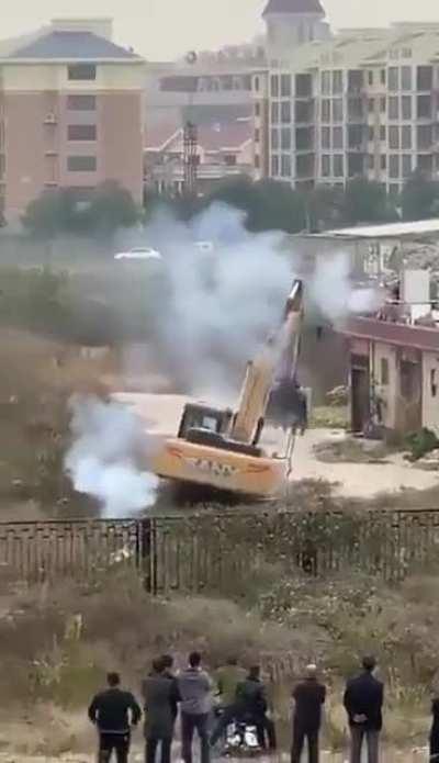 Man in China uses fireworks to fight off bulldozer sent to demolish his building