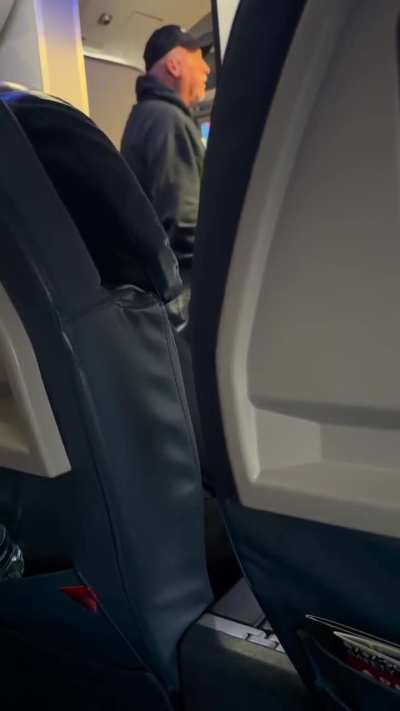 Man opens airplane door on tarmac for flight from ATL to ORD