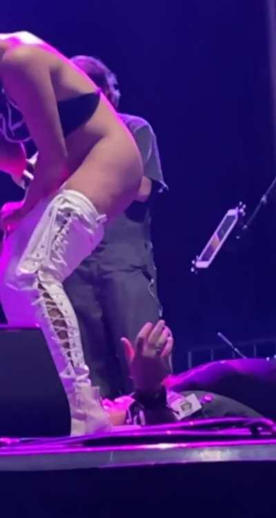 Singer on stage pees on a fan during performance.