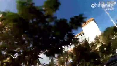 Chinese border patrol officer chases drug trafficker and continues the chase through a river; December 2023, in Mangshi city, Yunnan.