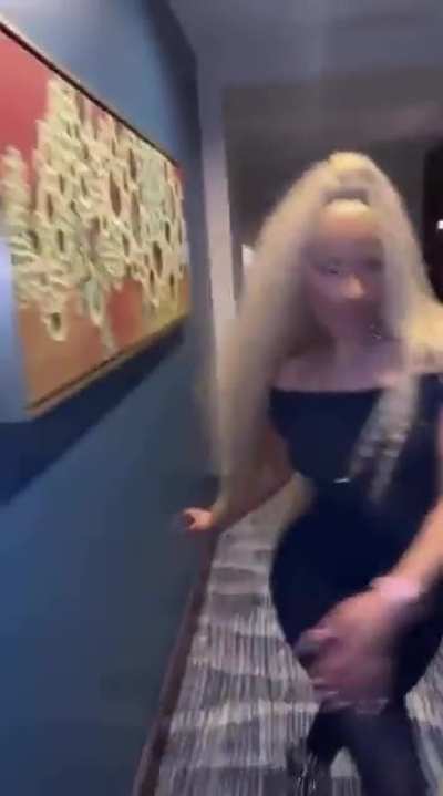 Nicki strutting down the aisle dramatically and clapping her cheeks