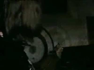 David Gilmour tuning Roger Waters' bass.