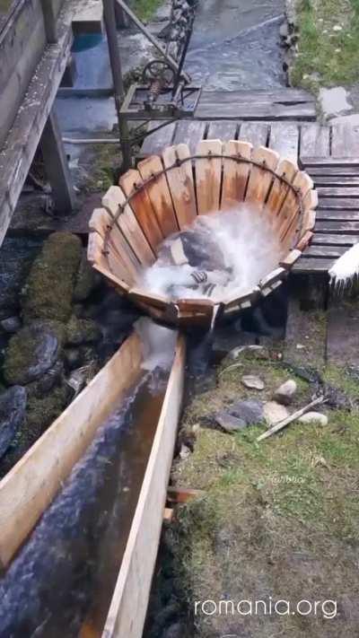 Traditional mechanism (vâltori) for washing clothes under running water from a river in Romania
