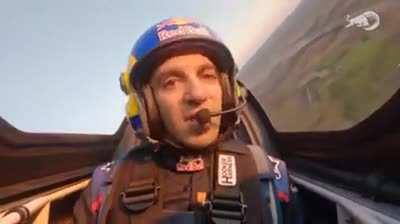 Dario Costa flies a plane through two tunnels.