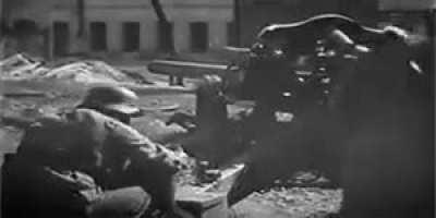 Waffen SS soldiers fire a 10.5 leFH 18 howitzer at point blank range during street fighting in Kharkov, 1943.