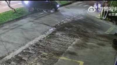 Survived by a rock, man crawls out from under the car.