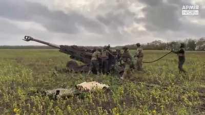 An M777 and ammunition is readied to fire in a new firing position, fires, then is towed away by an interestingly marked FMTV truck