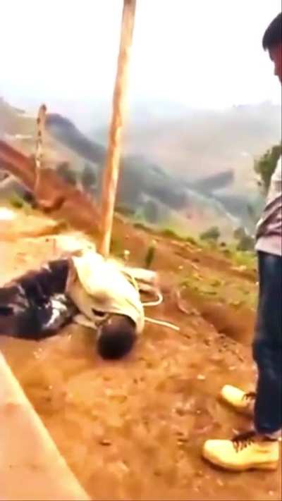 Chinese employer assaulting tied up African workers.