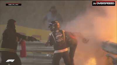 Grosjean helped out from the flames