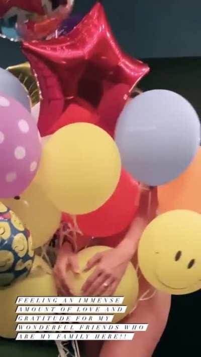 Naked behind balloons