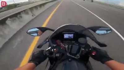 Erratic truck driver clips rider on the highway.