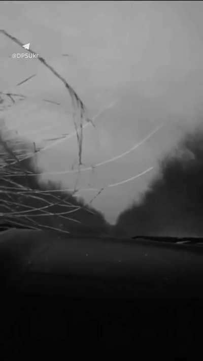 First-person footage by a Ukrainian soldier of the State Border Guard Service filming a drone strike on their car. Fortunately, the UAV did not explode, just ricocheting off the hood and damaging the windshield.
