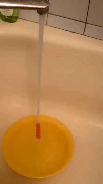 Straw ascends tap water stream