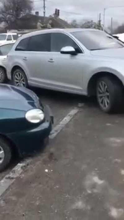 Russian tank crushing cars in traffic on the streets of Ukraine