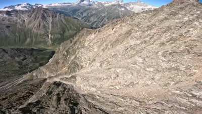 Guy casually jumps from the top of a mountain then flies a bit