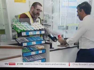 Chancellor first time in a shop (I assume) trying to use contactless by putting it to a barcode reader.